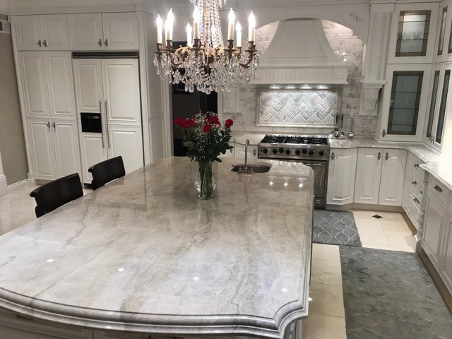 white kitchen calacatta oro marble backsplash cararra marble column taj mahal polished quartzite countertops crema marfil marble floor with dark emperador dot (2) grand quartzite kitchen